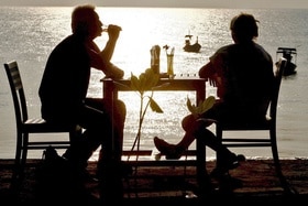 Couple assis buvant l apéro en bord de mer