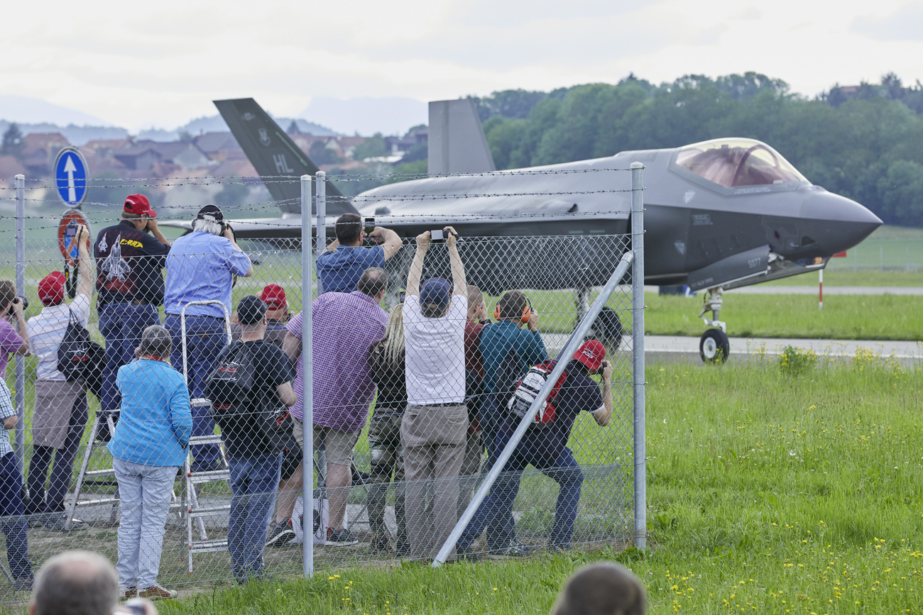 Des curieux photographient un chasseur F-35 lors d'une démonstration en Suisse.