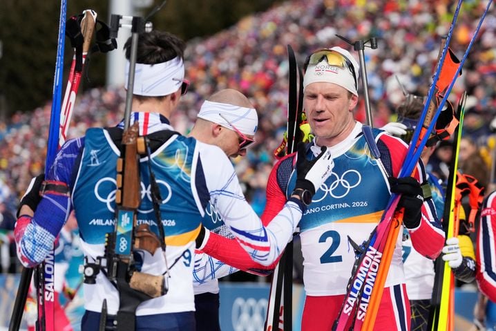Vetle Sjaastad Christiansen, de Norvège, à droite, accueille Eric Perrot, de France, après la course de biathlon de poursuite masculine de 12,5 kilomètres aux Jeux olympiques d'hiver de 2026 à Anterselva, en Italie, le dimanche 15 février 2026.