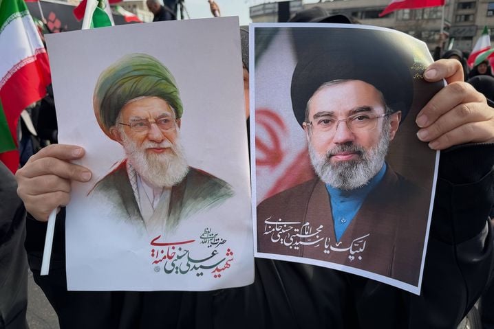 Une femme tient des affiches représentant l'ayatollah Mojtaba Khamenei, à droite, successeur de son défunt père, l'ayatollah Ali Khamenei, à gauche, en tant que guide suprême.