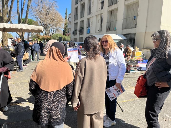 Des militants tractent pour Olivier Galzi sur un marché en périphérie du centre-ville.
