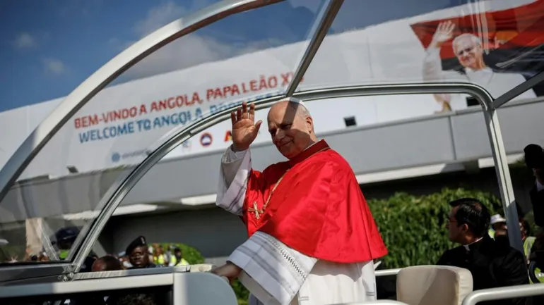 Le pape Léon XIV salue la foule depuis la papamobile à son arrivée à l’aéroport de Luanda le 18 avril 2026, lors de la troisième étape de sa tournée africaine.